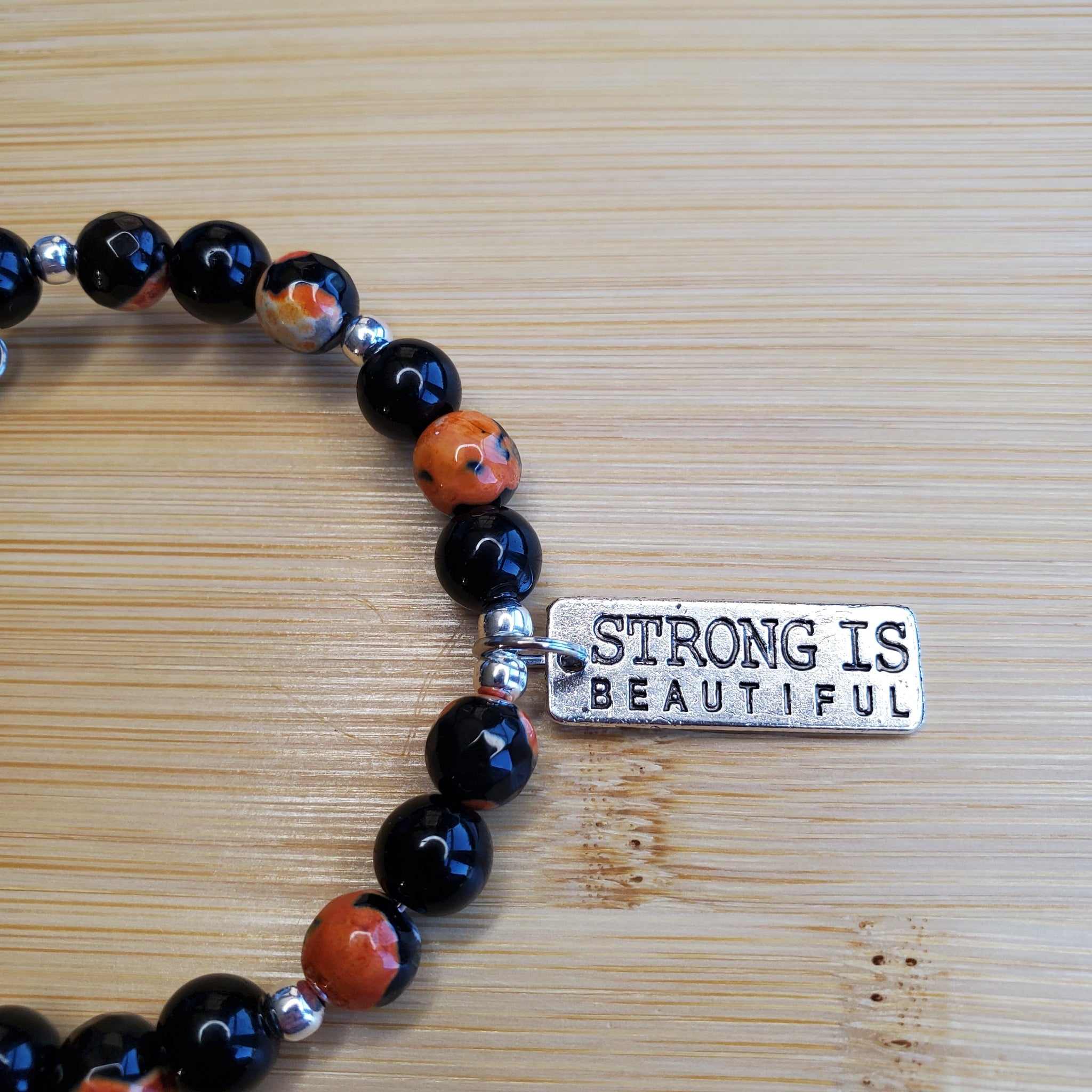 Strong is Beautiful in Orange and Black Bracelet (MW) | Mamabug ReCreations - Artisan Jewelry